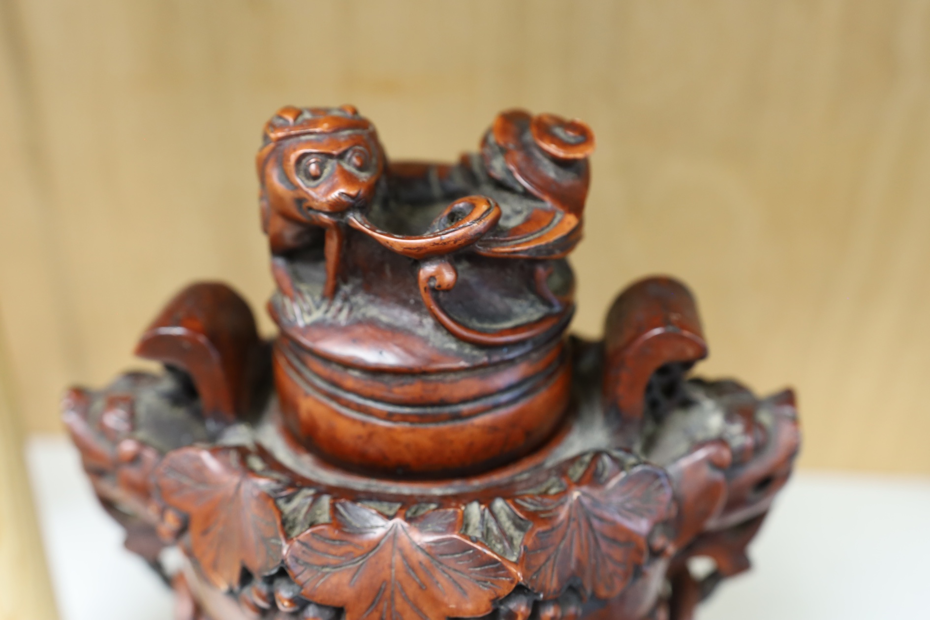 A Chinese composition tripod censer and cover, wood stand, 22.5cm high. Condition - fair